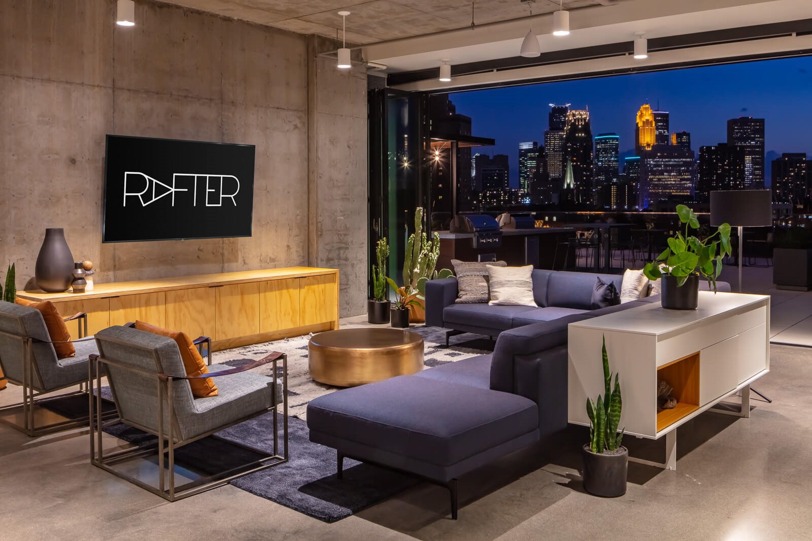 Clubroom seating and minneapolis skyline at night time